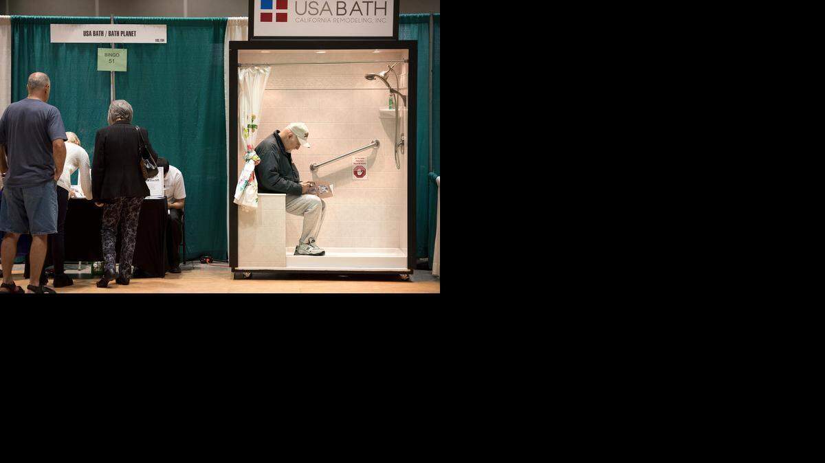 Larry Borba of Escalon reads a brochure about walk-in showers at the Stanislaus County Home & Garden Show at Modesto Centre Plaza <137>in Modesto <137>on Friday<137>, March, 06, 2015<137>.