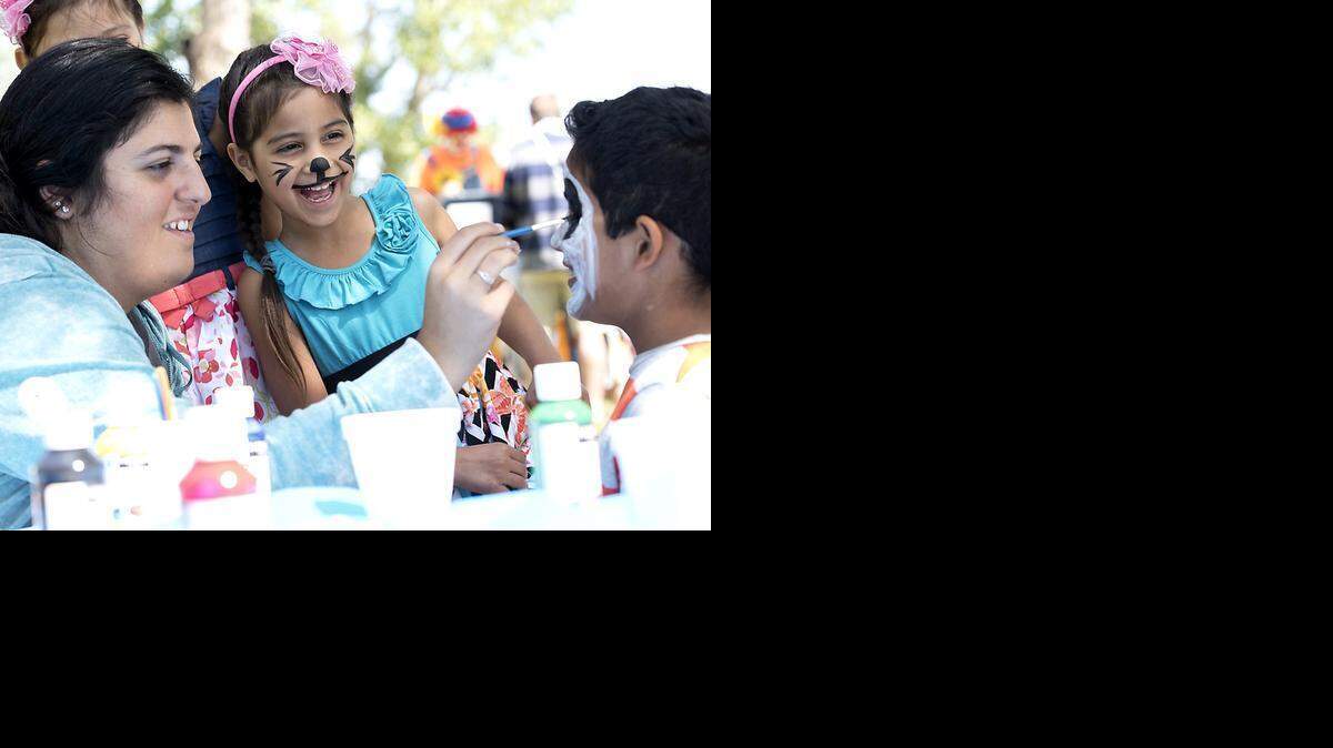 
Jizelle Montoya, 6, enjoys watching Sharokeena Atanus, left, transform Angel Morales, 8, with face paint at the Stanislaus County Easter Egg Hunt at Modesto Reservoir in Waterford on Saturday.
