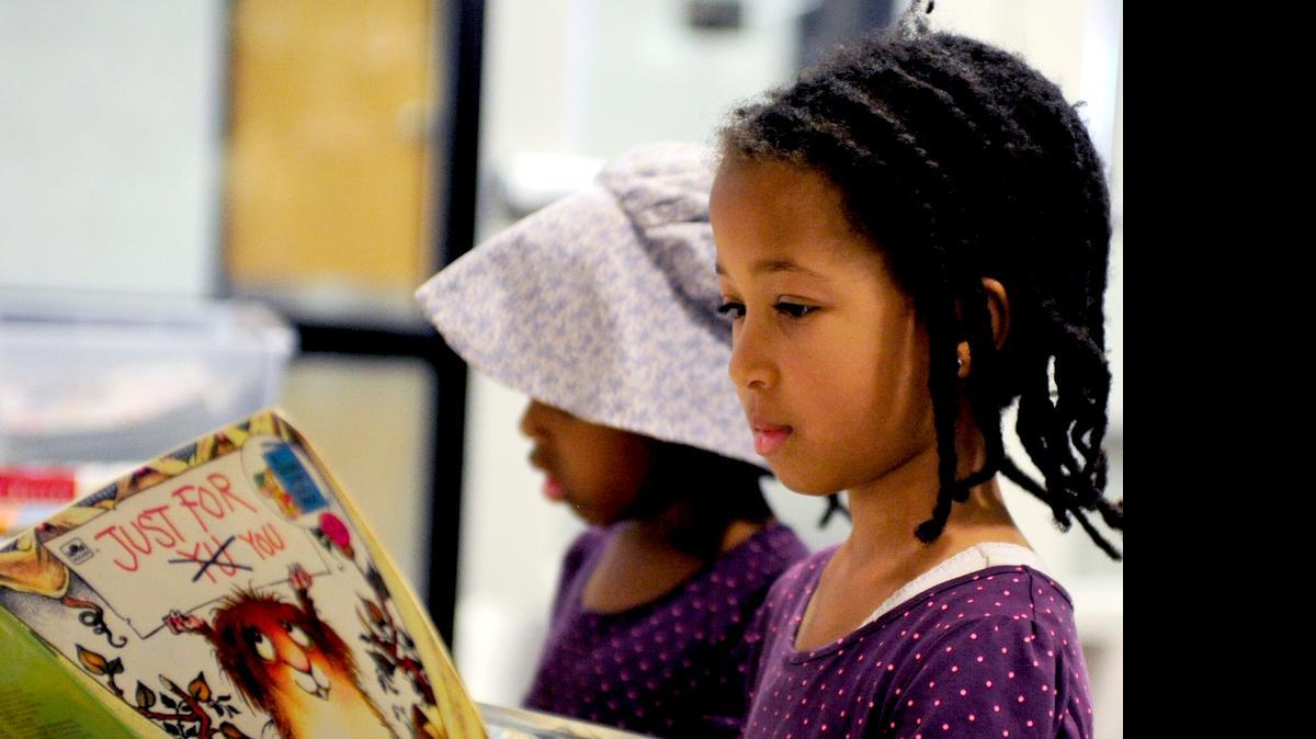 
After checking out books from the Stanislaus County Library’s Salida branch, Liberty Marshall, 6, right, and sister Emmeline, 5, look at children’s books Monday. The Stanislaus READS initiative is an effort to help children read and succeed by third grade. County libraries are among the agencies involved in the initiative.
