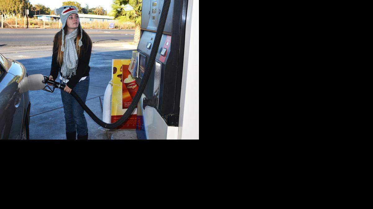 
Heather Johnson of Turlock gets gasoline at the AM/PM station at North Olive Avenue and Golden State Boulevard Tuesday morning. Gas prices have been falling in recent weeks to levels not seen in some time. October 27, 2014.
