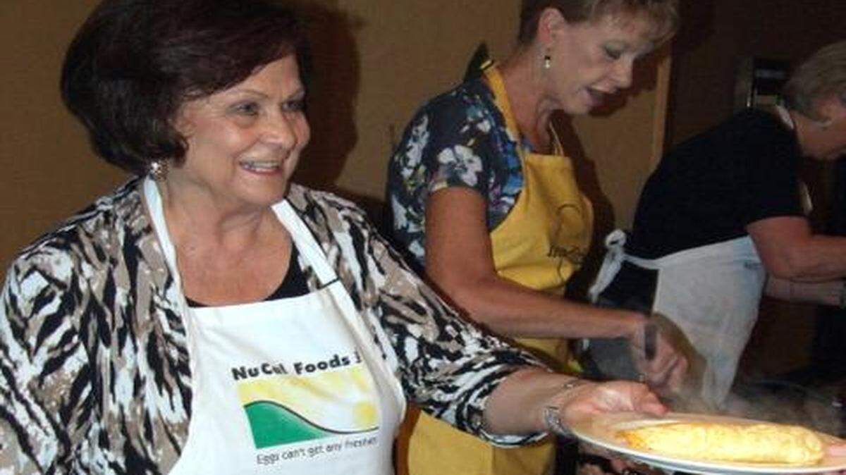 
Arline Mello, (left) and Tracy Lape, both with Nucal Foods of Ripon, serve up custom-made omelets at the 52nd annual Good Egg Breakfast in Modesto on Thursday. The state’s egg industry puts on the breakfast to honor a supporter with the Good Egg Award and raise scholarship money for Modesto Junior College agriculture students.
