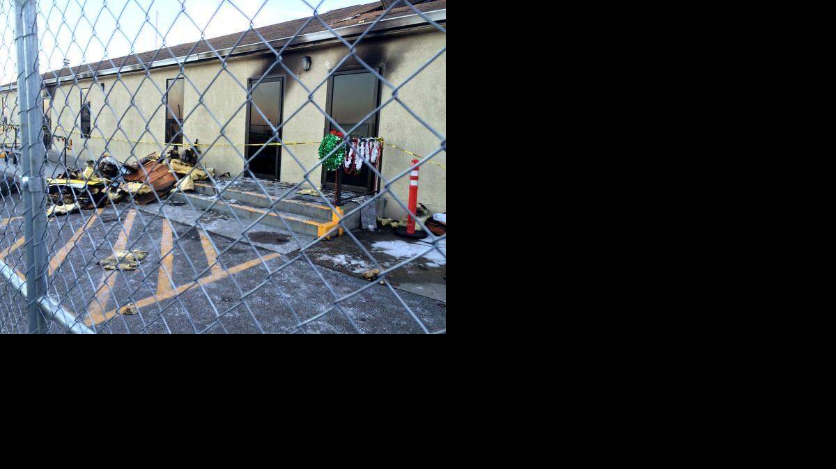 
Damage and debris outside Holy Family Catholic Church’s Nazareth Hall, fenced off Saturday afternoon after an early morning fire.
