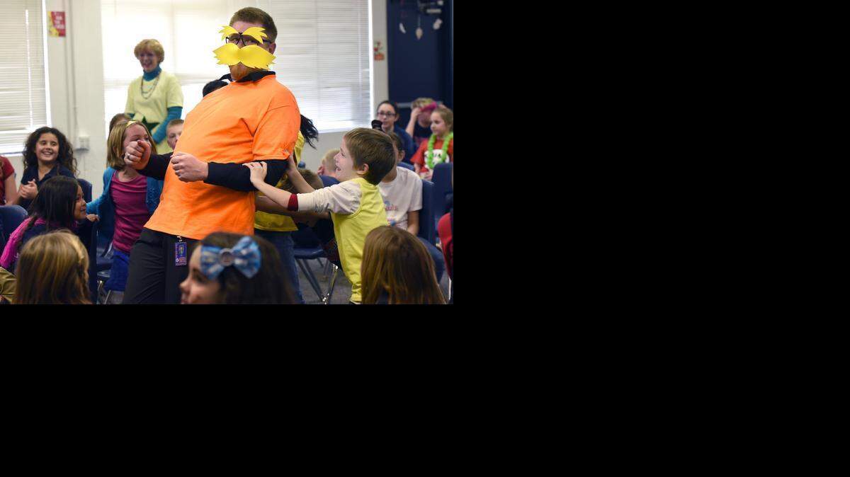 
Modesto Christian Elementary/Middle School principal Matt Diehl, dressed as the Lorax, is pushed on stage by Connor DeShields to participate in a game on Monday afternoon.
