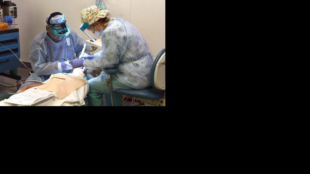 
Sam Pate, left, and Virginia Augsbery perform dental work on a child at Salida Surgery Center earlier this month.

