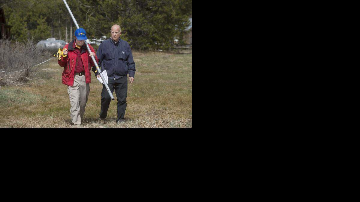 
Frank Gehrke of the California Department of Water Resources and Gov. Jerry Brown walk out into a snowless meadow during the annual snowpack survey in Phillips on Wednesday. For the first time since measurements began in 1942, there was no snow to measure on this date. 
