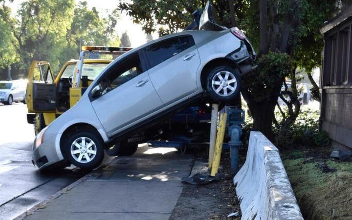 A driver was unhurt but had to be helped out of her car after she spun out on rain-slick Scenic Drive in January 2017, hit the curb and concrete barriers and ended up with the rear of her car stuck on pipes that protect a water backflow prevention assembly.