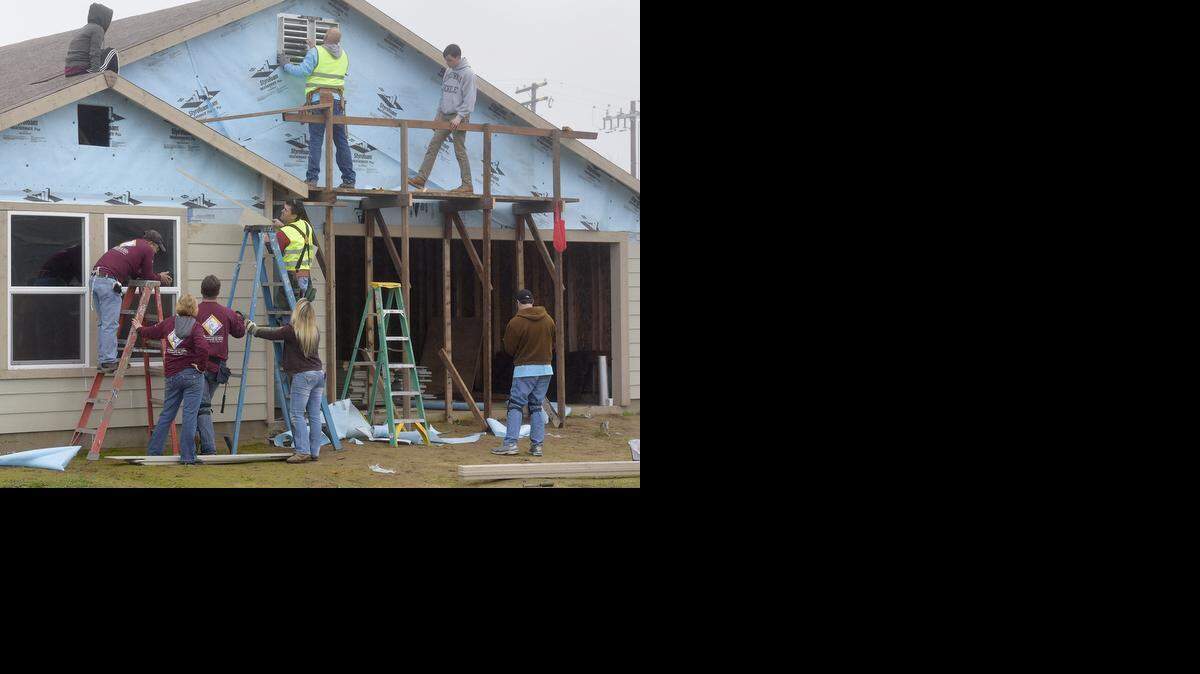 
Volunteers use their Martin Luther King Jr. holiday to help Habitat for Humanity with construction at the River Vista subdivision.
