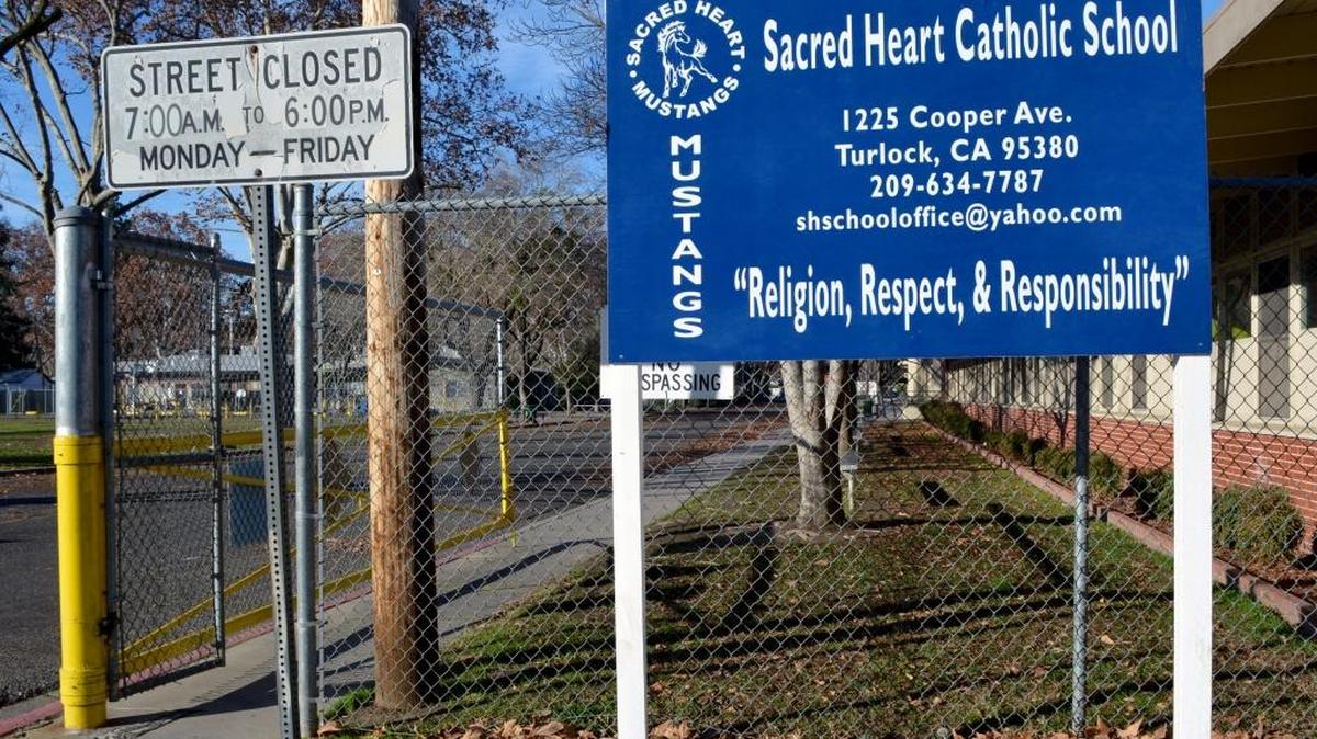 Sacred Heart Catholic School splits its campus over two sides of Cooper Avenue in an older neighborhood of Turlock. The city will consider setting a public hearing on giving up the one block of pavement Tuesday, which would allow the campus to connect its two halves as a safety measure for children at the school, on the right, and preschool, seen in the background on the left.