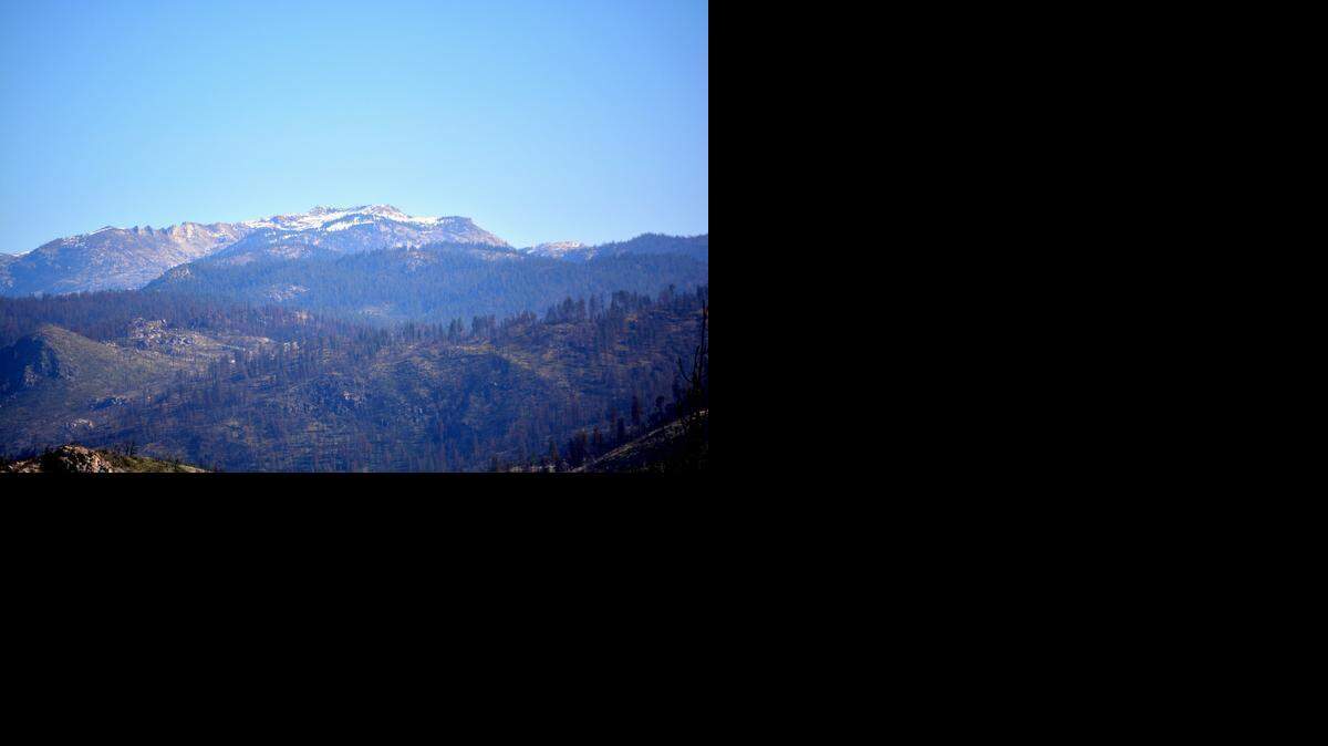 
 The poor snowpack in the High Sierra is evident Monday on these mountains in Yosemite National Park, seen from Camp Mather Road.
