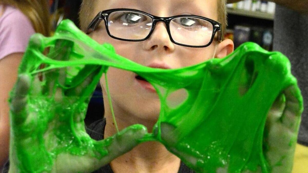 
Johnathan Smith, 6, shows off sticky, stringy monster blood during the Turlock Library Goosebumps event.
