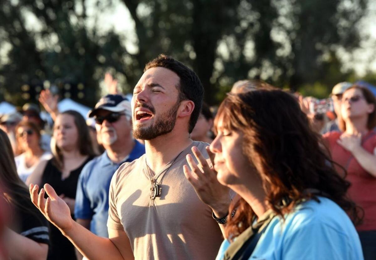 Kaeden Lara of Waterford, Calif. prays during Franklin Graham's Decision America California Tour at the Turlock Fairgrounds on Tuesday evening May 29, 2018.