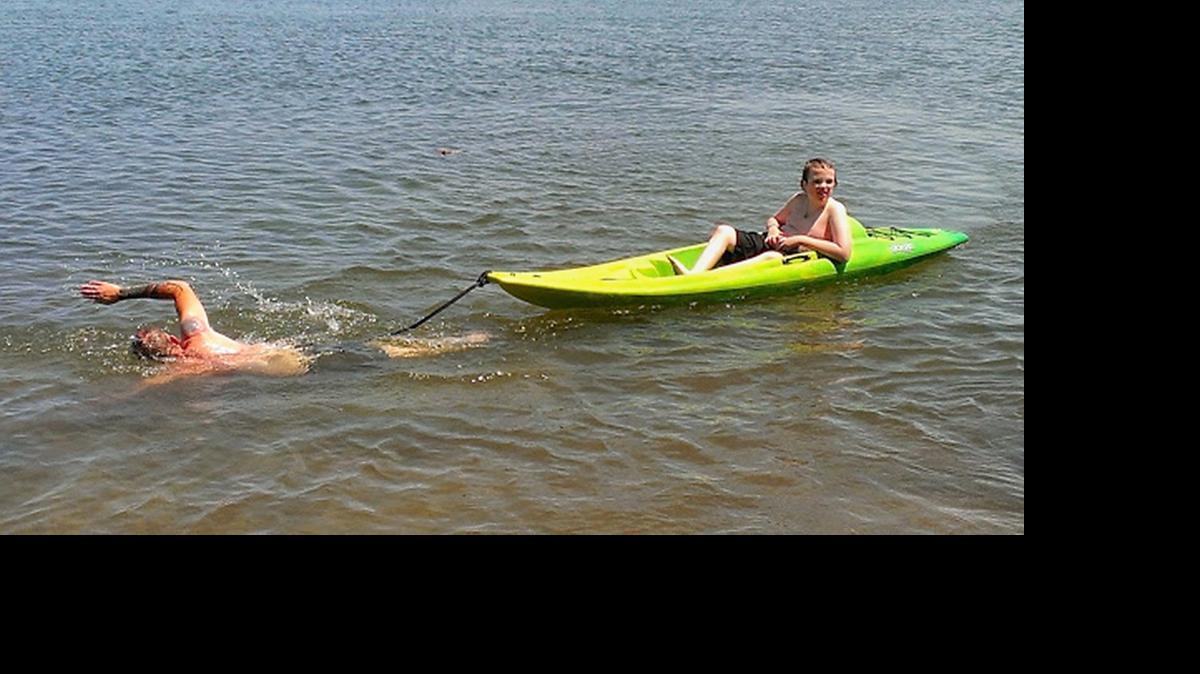 
Dad Harry Boucher pulls son Max, in the kayak, through the water while training for the Lake Del Valle Open Water Swim in May 2014. The team will be back in the water taking on an 11-mile marathon across Lake Tahoe on Sunday.
