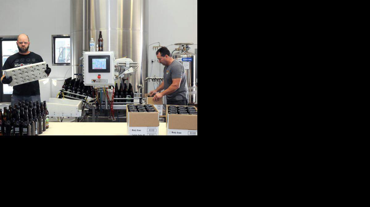 
Owner John Freitas, right, and Davey Miksza bottle beer on Monday morning (11-03-14) at Sandude Brewing Co. in Turlock, CA.
