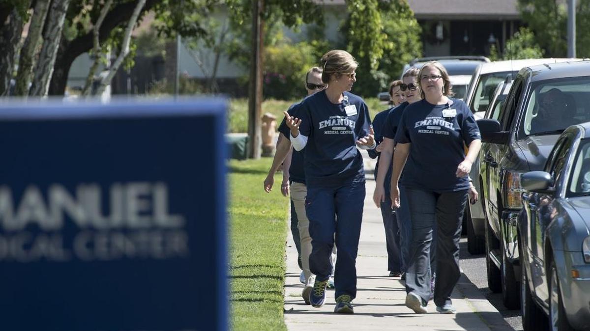 Staff members at Turlock’s Emanuel Medical Center take part in an outing to commemorate National Walking Day on Wednesday, April, 6, 2016.
