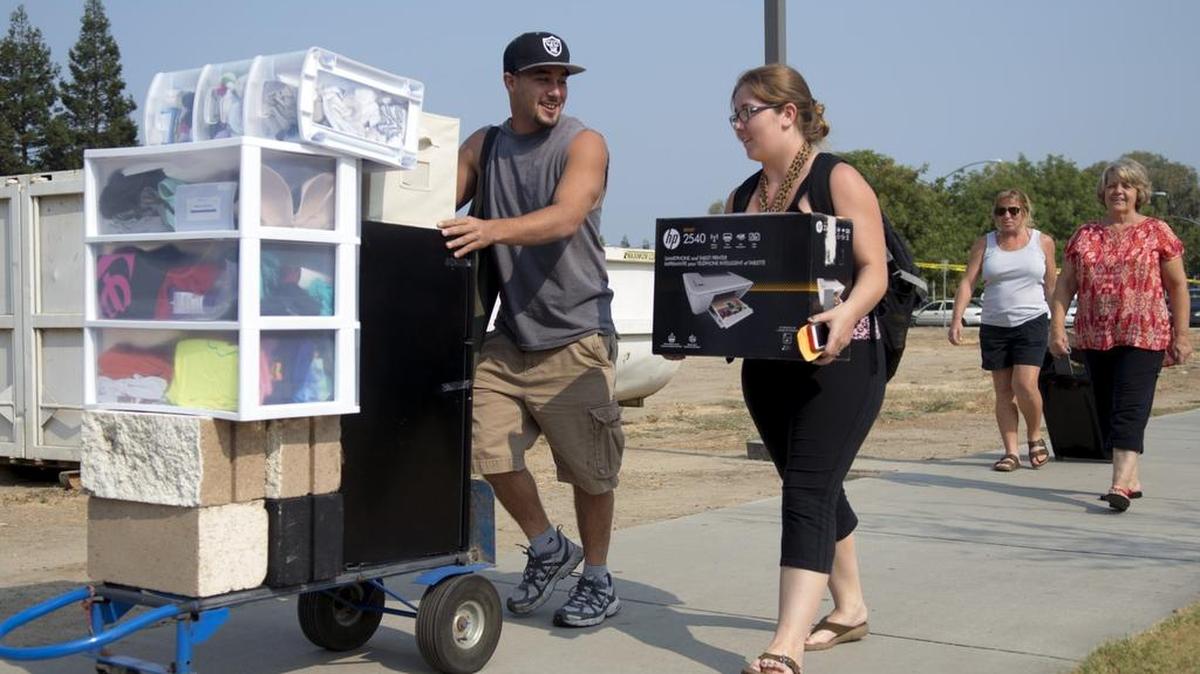 
Robert Wise, left, helps his sister, Kayla Wisemove in to the dorms during Move-In Day at the Stanislaus State dorms in Turlock on Friday.
