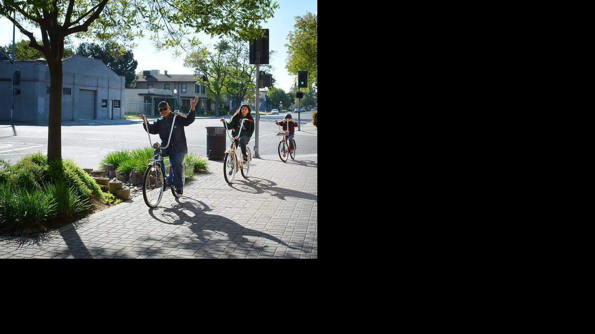 
In April 2014, Turlock city worker Jose Garcia and daughters Nayeli, then 14, and Daisy, then 10, pedal to a meeting at City Hall on making Turlock a more bike-friendly city.
