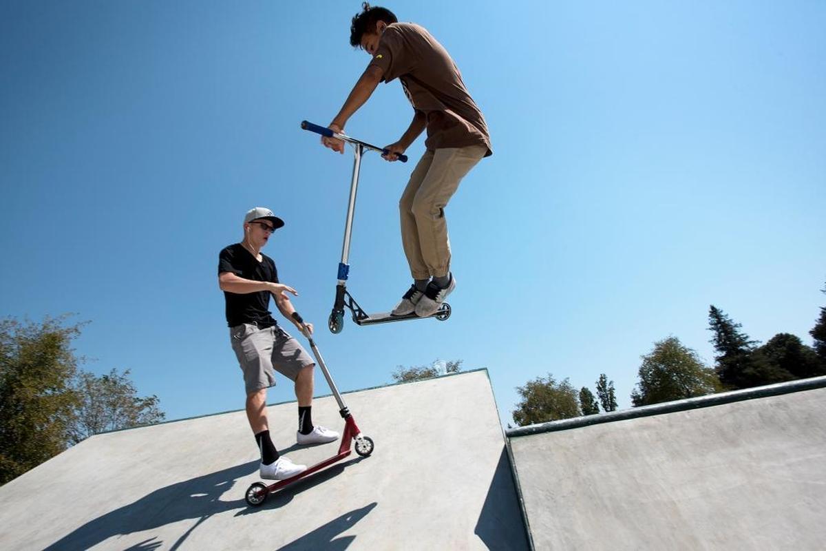 Nick Gonzalez, 15, right, catches some air on his scooter as he and Caden Speckens, 16, left, ride at the new Brandon “Cookie” Koch Memorial Skate Park at Donnelly Park in Turlock, Calif., on Sunday, Aug. 28, 2016.