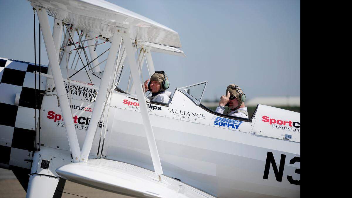
World War II pilot Charles Walker, 94, in front cockpit, salutes before takeoff with pilot Darryl Fisher from Turlock Municipal Airport.
