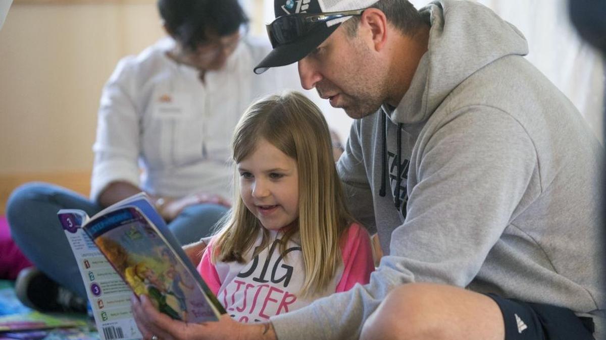 Jason Plett reads to daughter Hadley, 4, during the Carnegie Arts Center’s 100th birthday party in Turlock on Saturday, Feb. 27, 2016.