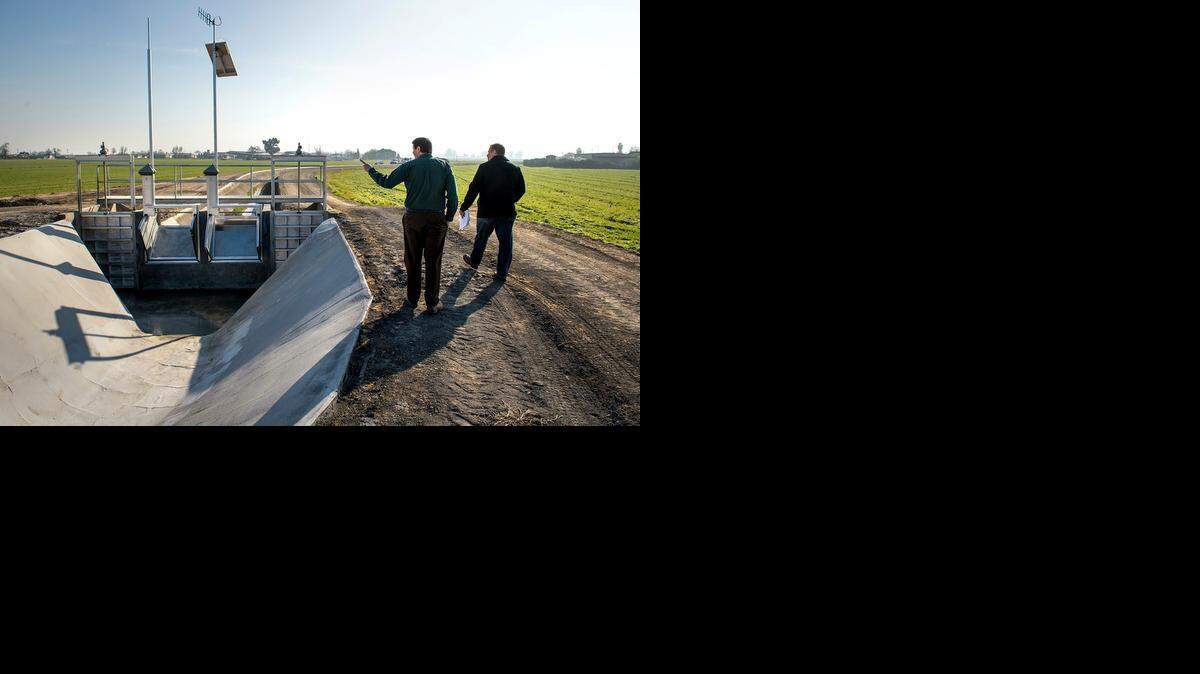 
Turlock Irrigation District engineers Matt Hazen, left, and Brad Koehn look at a new canal drop gate on the Lateral 8 canal in Hilmar on Tuesday.
