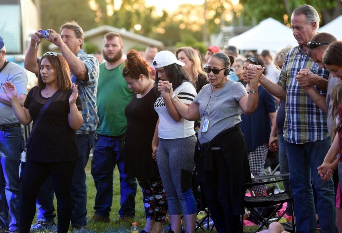 People hold hands and pray during Christian evangelist Franklin Graham's Decision America California Tour at the Turlock Fairgrounds on Tuesday evening May 29, 2018.
