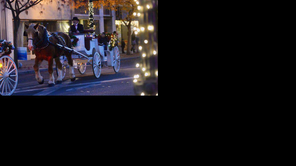 
Two horse-drawn carriages gave rides in downtown Turlock at the Festival of Lights in Turlock on Friday.
