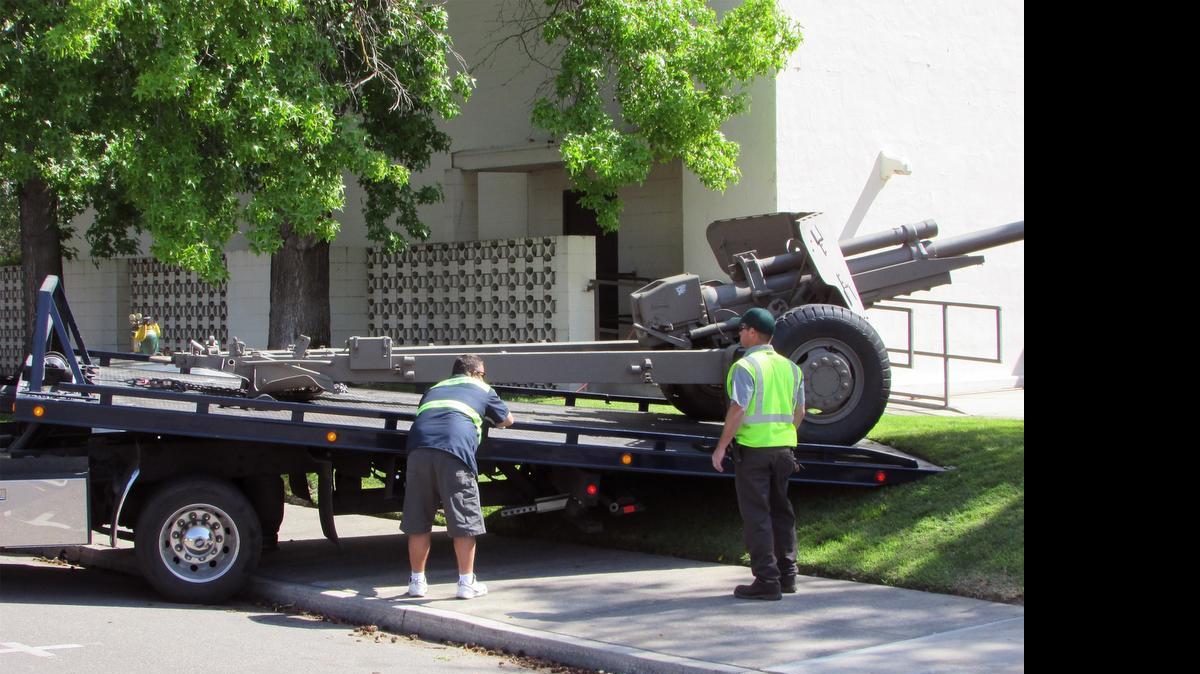 
Kevin Samora of Turlock City Tow, left, and city employee Michael Murphy help move a Korean War cannon from in front of the War Memorial building in Turlock this month. The city is seeking ideas on a new home for the cannon because the building is being sold to the Turlock Irrigation District, which has its headquarters next door.
