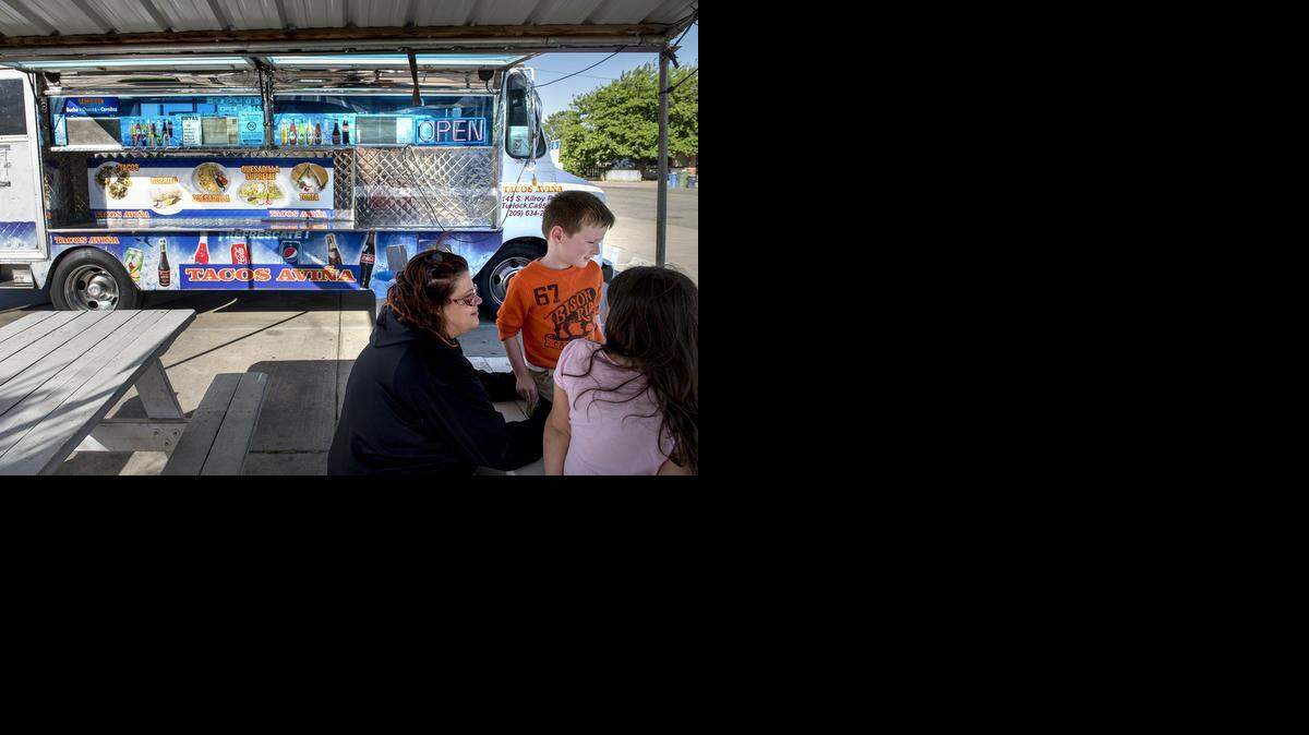
Melanie Pippin, 5-year-old son Caleb and niece Mazie Kaminski, 6, wait for their order of Mexican food at Tacos Aviña on Center Street in Turlock on Wednesday.
