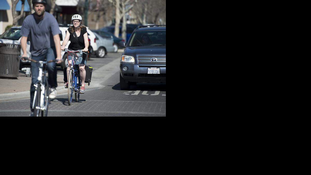 
Bicycle advocates Elizabeth Claes and her husband, John, ride down a busy Main Street in Turlock on Thursday.
