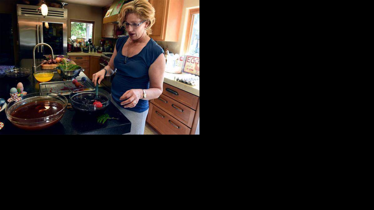 
Kristi Gemperle colors Easter eggs last week at her Turlock home using natural ingredients such as beets, turmeric, purple and onion skins.
