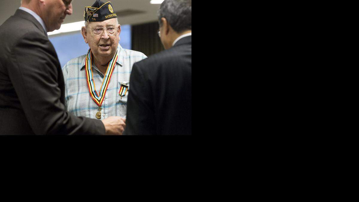 
Modesto veteran Richard Marlow receives the Ambassador for Peace Medal for his service in the Korean War from the South Korea consul general in San Francisco, Han Dong-Man, and Rep. Jeff Denham, R-Turlock, during a ceremony at California State University, Stanislaus, in Turlock on Tuesday.
