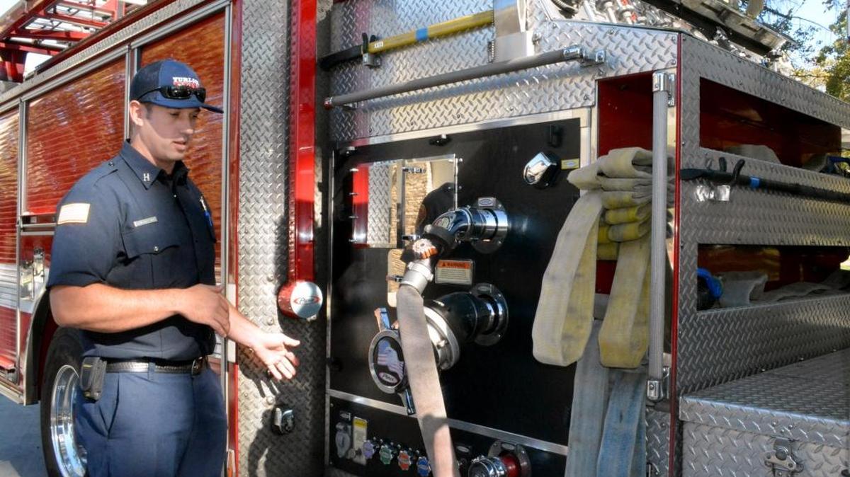 
Turlock fire Capt. David Mallory, at Station 1 in Turlock, on Sept. 23, 2015, shows an existing fire engine, with its walk-through pumping module and top-mounted guages damaged by sun exposure. Side-mounted axes, hoses and nozzles are easy to steal, and jury-rigged storage traditional in fire rigs will be replaced with efficient, ergonomic storage in the new engine Mallory helped design. 
