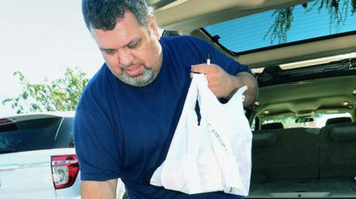 
Jesse Casey of Modesto loads his car with items packed in plastic bags, but says he usually gets paper. In September, Gov. Jerry Brown signed Senate Bill 270, which bans single-use plastic bags at larger stores starting in July and at smaller stores a year later. 

