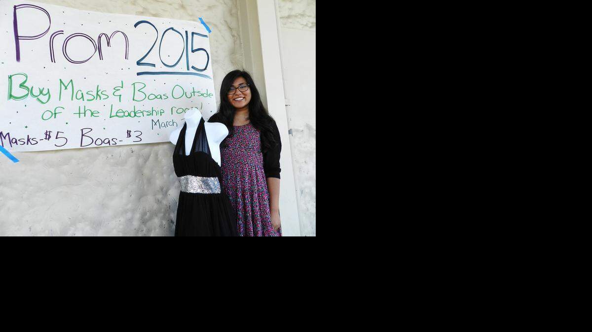 
Prachi Bulsara, a senior at Davis High, is the coordinator of the school’s chapter of Becca’s Closet. On campus Thursday, she shows one of the prom dresses available this year.
