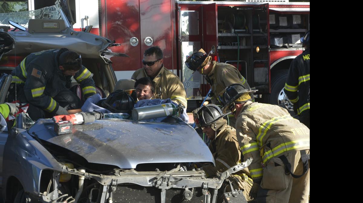 
The driver of a Toyota Highlander was trapped inside the crumpled vehicle for about 20 minutes after he turned onto G Street from First Street and crashed into a tree Wednesday evening.
