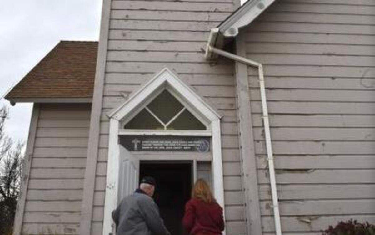 
People visit the former United Brethren Church on North Third Avenue in Oakdale on Friday morning. The city of Oakdale held an open house at several properties it owns today. One of them is the church built in 1893. They are accepting proposals from businesses, nonprofits and individuals about how they might restore the buildings.
