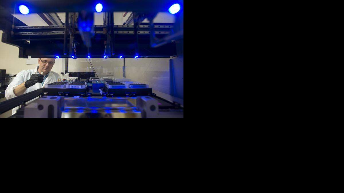
In 2013, microbiologist and supervisor Josh Whitworth works with a state-of-the-art robotic Polymerase Chain Reaction device that screens for bacteria at Foster Farms in Livingston as part of preventive measures to reduce salmonella to maintain a higher than required standard for their products.
