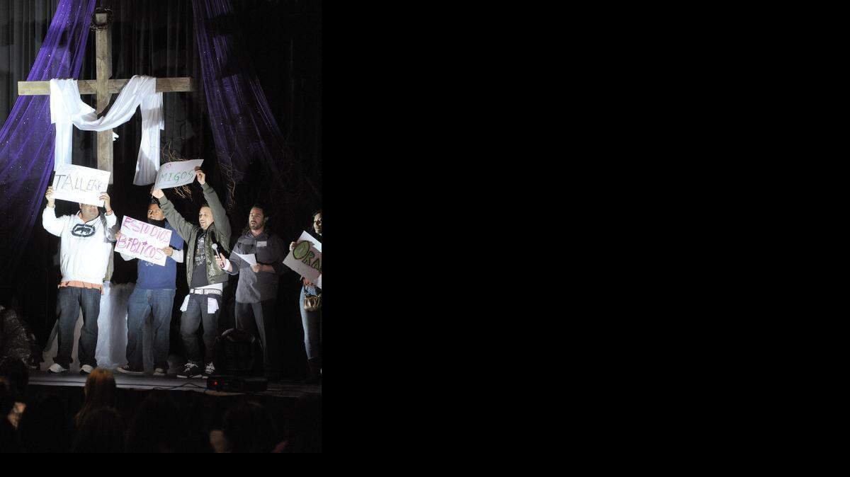 
A performance is acted out on stage while a wooden cross is illuminated behind the performers during the 2013 Catholic Hispanic Youth and Young Adults Congress at Modesto Centre Plaza.
