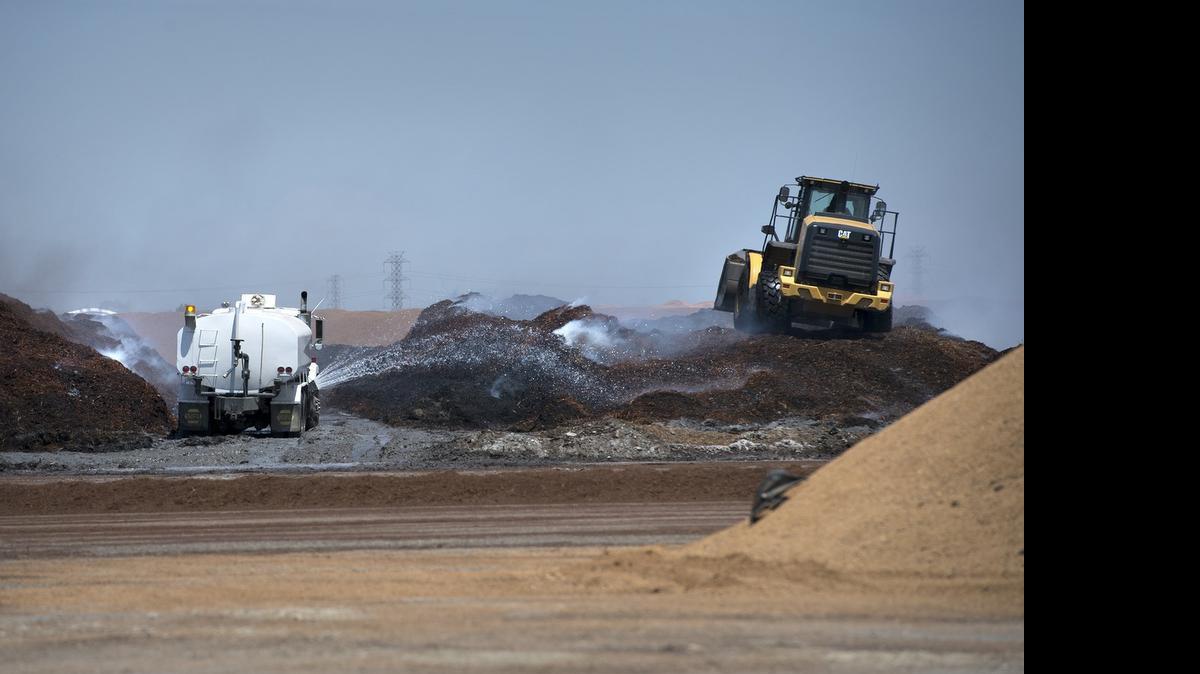 
Crews work to contain a fire at a compost facility on South Tracy Boulevard in Tracy, Calif., on Wednesday, May, 20, 2015.

