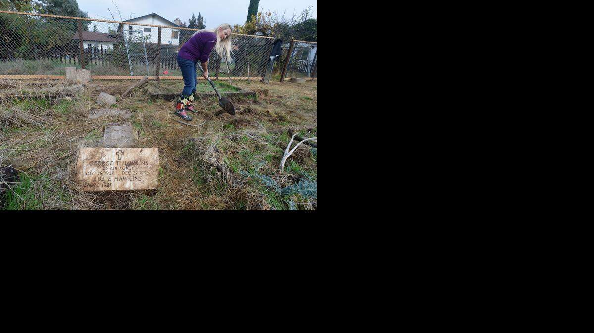
Hope Keller, mother of Amy Buenrostro helps dig, Nov. 13, 2014, in the area where most of the tombstones were found faced down between raised garden plots. Having purchased the home recently residents Javier and Amy Buenrostro found over a dozen overturned tombstones in their back yard.
