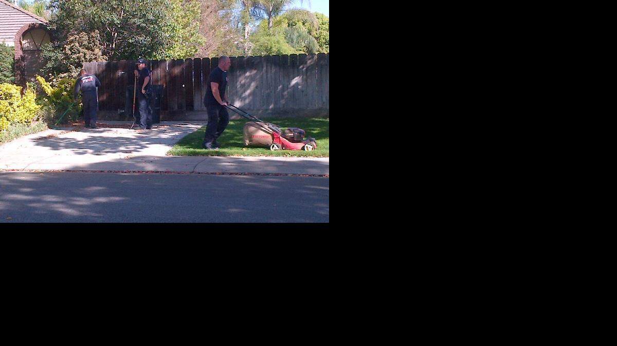 
From left, Modesto fire Engineer Dan Quirarte, Capt. Matt Curless and firefighter Rod Riley complete yardwork that an elderly man started before having a heart attack Wednesday.
