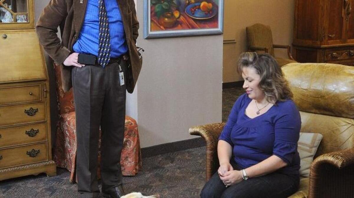 Dr. Garfield Pickell and his 8 year old yellow lab Rosie, visit with Roxanne Poole, daughter of a patient being cared for at the Alexander Cohen Hospice Housein Hughson Thursday (04-04-13) morning.
