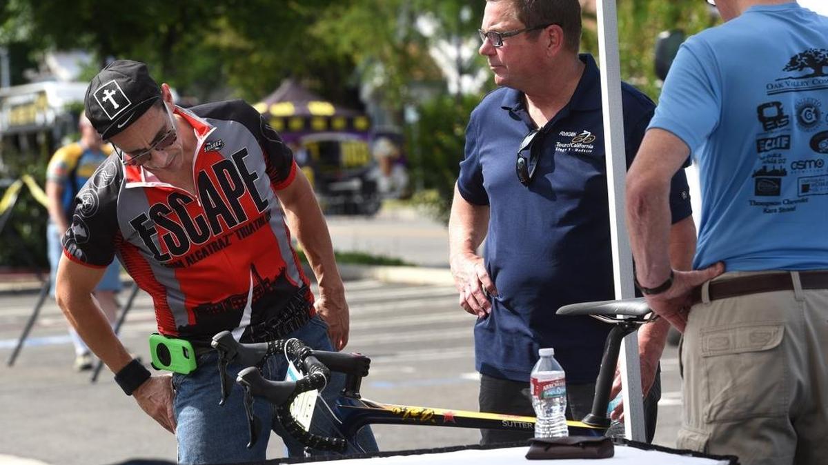 Efren Martinez (left) checks out a bike with David Cooperider Wednesday (05-18-16) at the Tour of California: Modesto Cycling Expo at K and 11th streets in downtown Modesto. The two were at the Stanislaus County Bicycle Club booth at the expo.