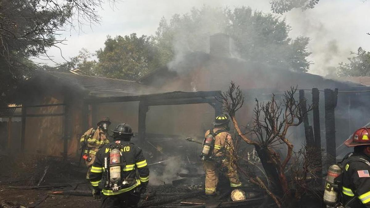 
Firefighters respond to a fire on Cheyenne Way that spread to a home on Rodeo Circle in north Modesto Saturday morning. 
