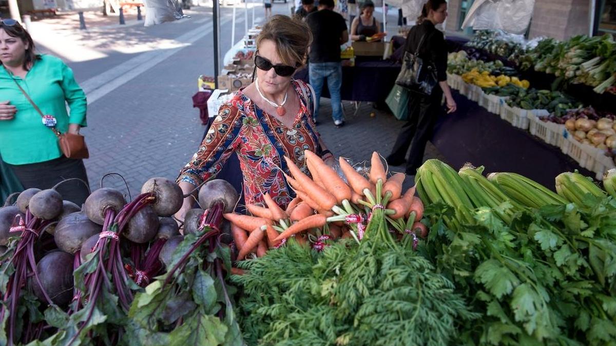 Sue Tylock of Modesto shops for fresh produce during the evening farmers market on 10th Street in Modesto on Thursday, June 2, 2016.