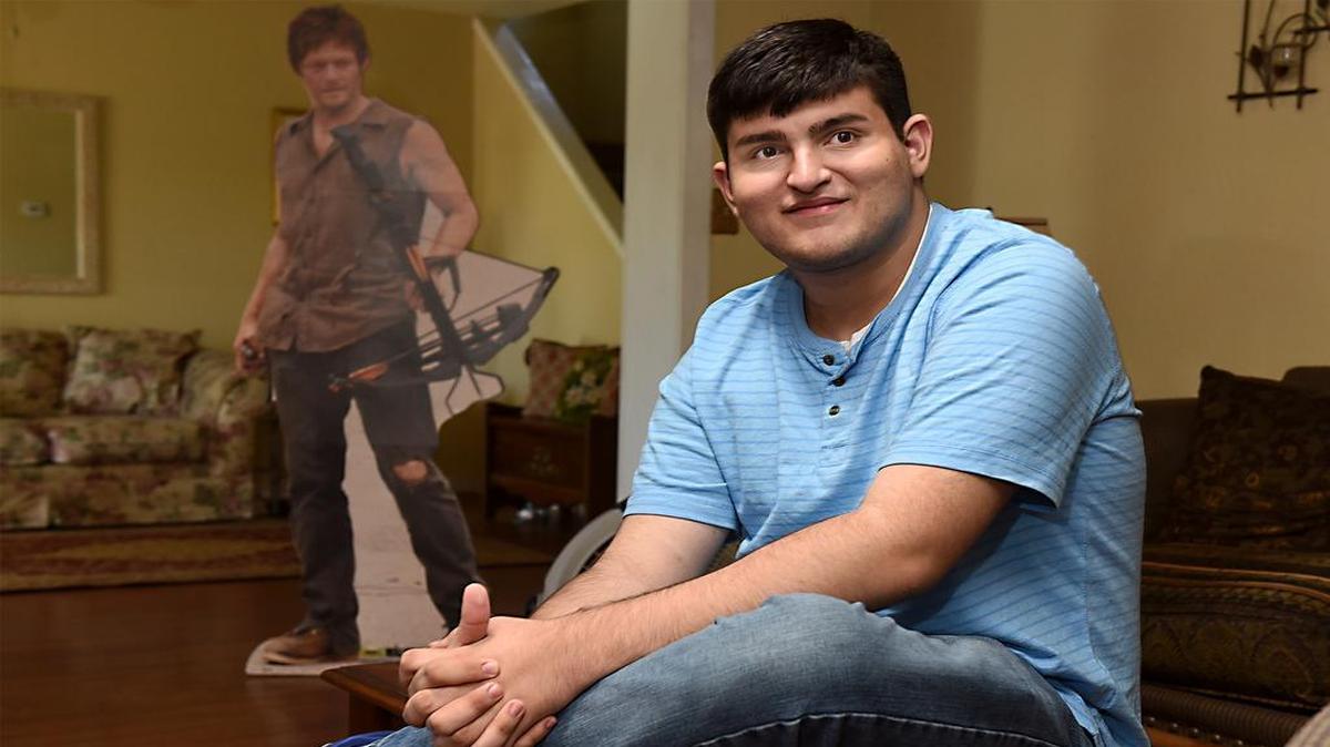 
Joseph Murillo, 19yrs of Ceres, Calif. is getting his Make A Wish granted. His wish is to meet Daryl Dixon (aka:Norman Reedus) from the Walking Dead TV Series. Murillo is pictured at his home on Thursday morning (06-11-15).
