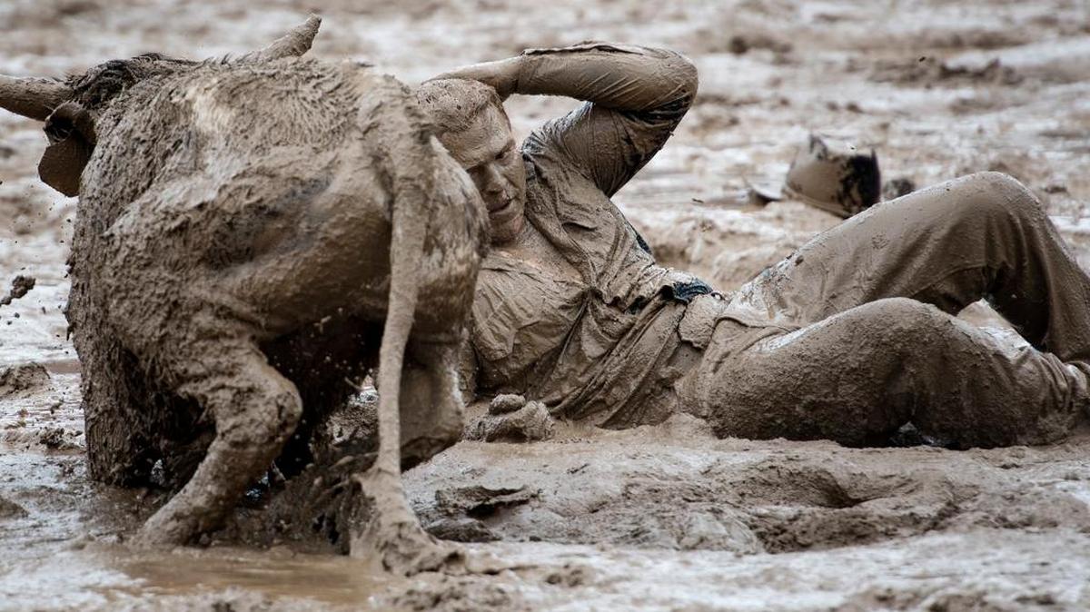 Kelly O'Day of Fortuna pulls himself out of the mud after wrestling down a steer in the steer wresting competition during the Oakdale Rodeo in Oakdale, Calif., on Sunday, April, 10, 2016.