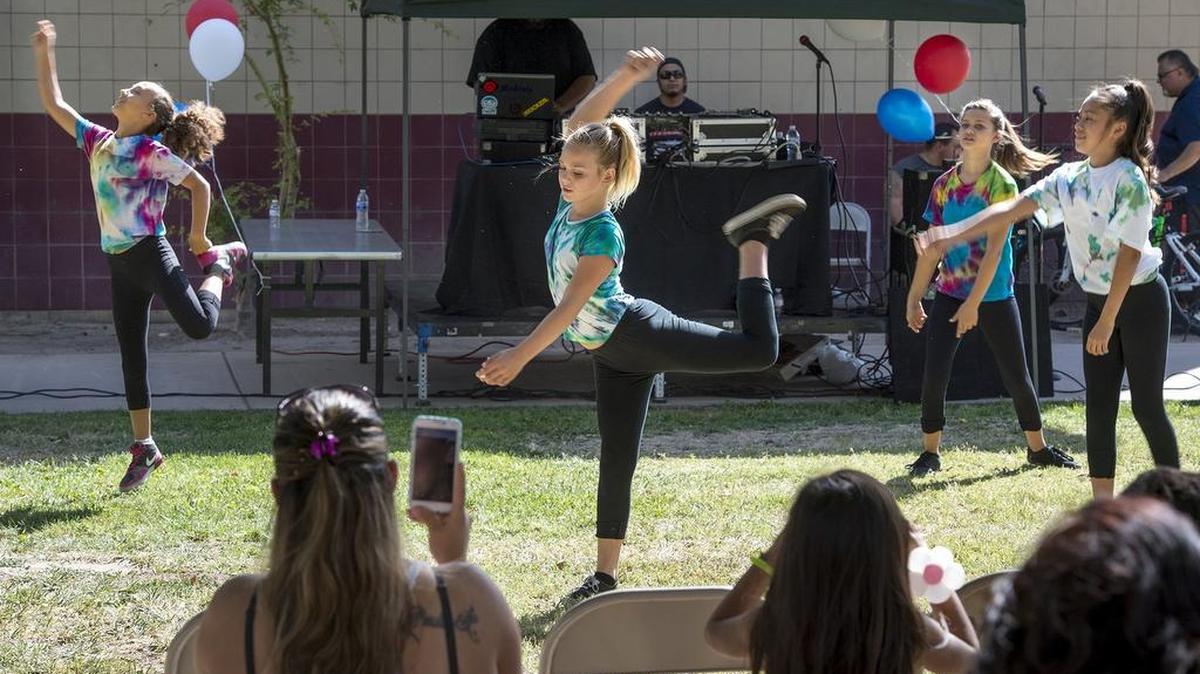 
The Dream Catchers dance group – from left, Tiara Gray, 11; Kelsey Guynes, 11; Tia Gray, 13; and Leticia Lopez, 11 – perform during the National Night Out celebration outside the Maddux Youth Center in Modesto on Tuesday.

