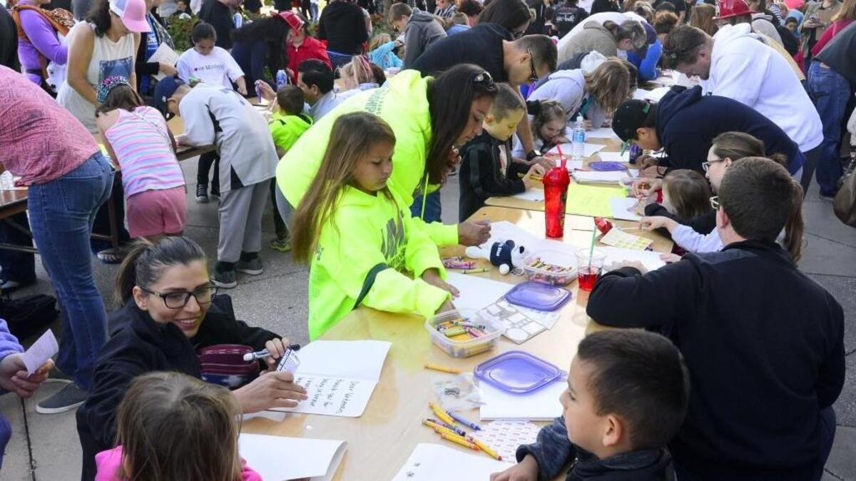 Volunteers write thank-you cards to active military service personnel during the 2016 Love Modesto event last April.