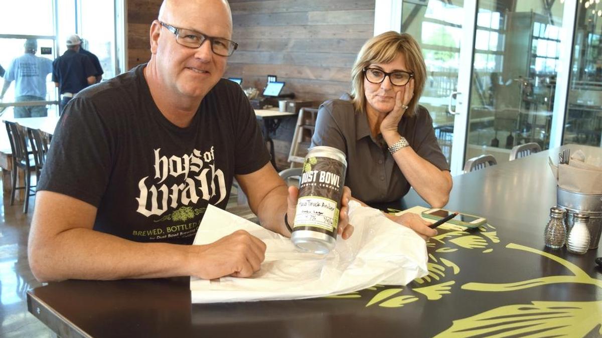 Dust Bowl Brewing Taproom owner Brett Tate and spokeswoman Michelle Peterson are pictured Monday, July 18, 2016, with a crowler of beer in Turlock.